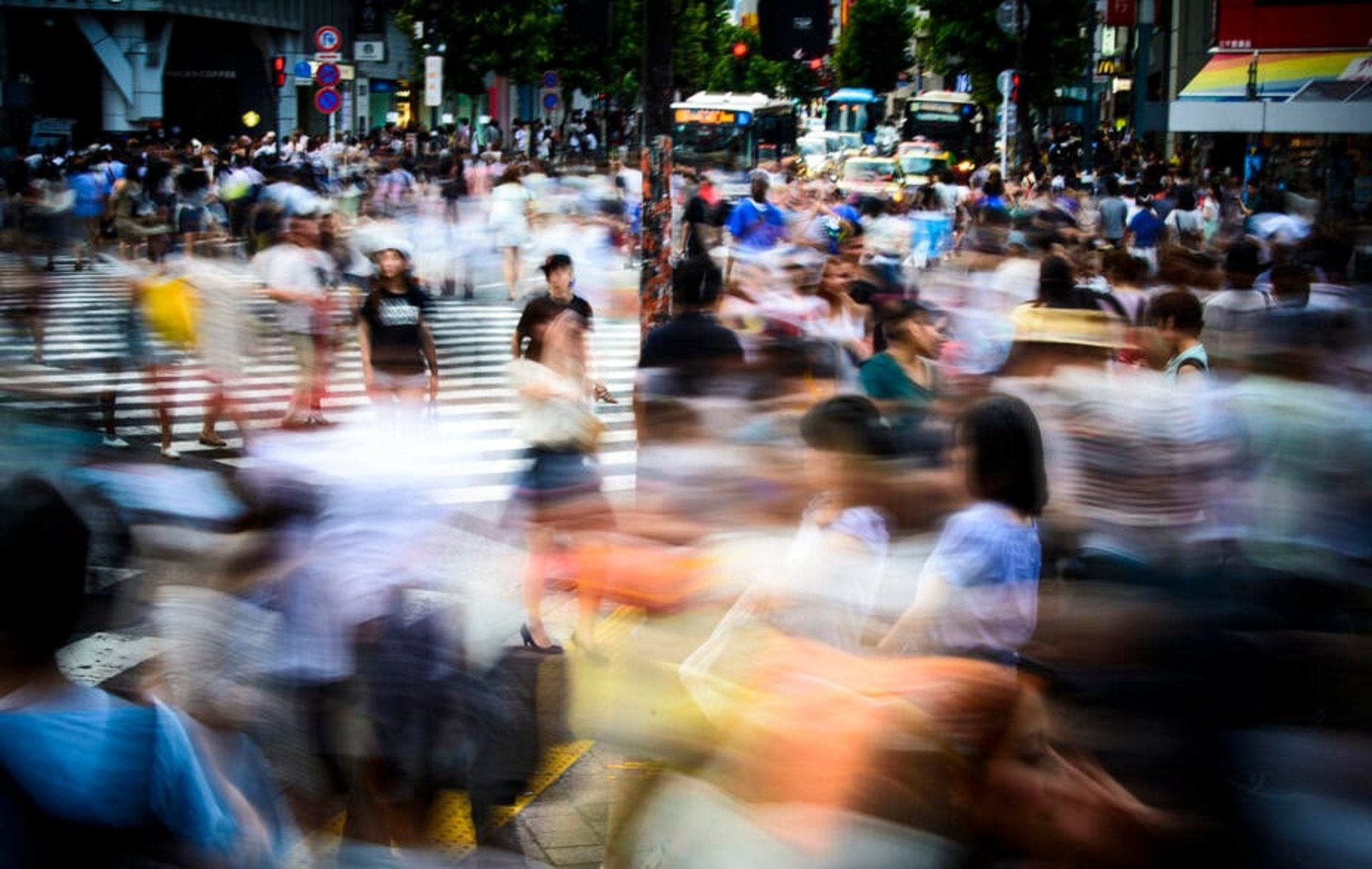 An explosion of motion and colour as a large crowd hurries through central Tokyo.