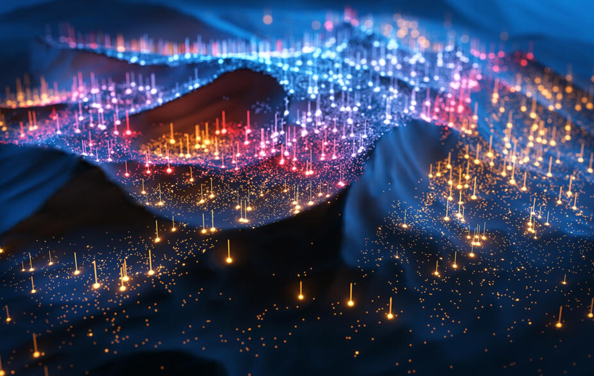 A digitally generated image of multi-coloured glowing data points floating on dark waves.