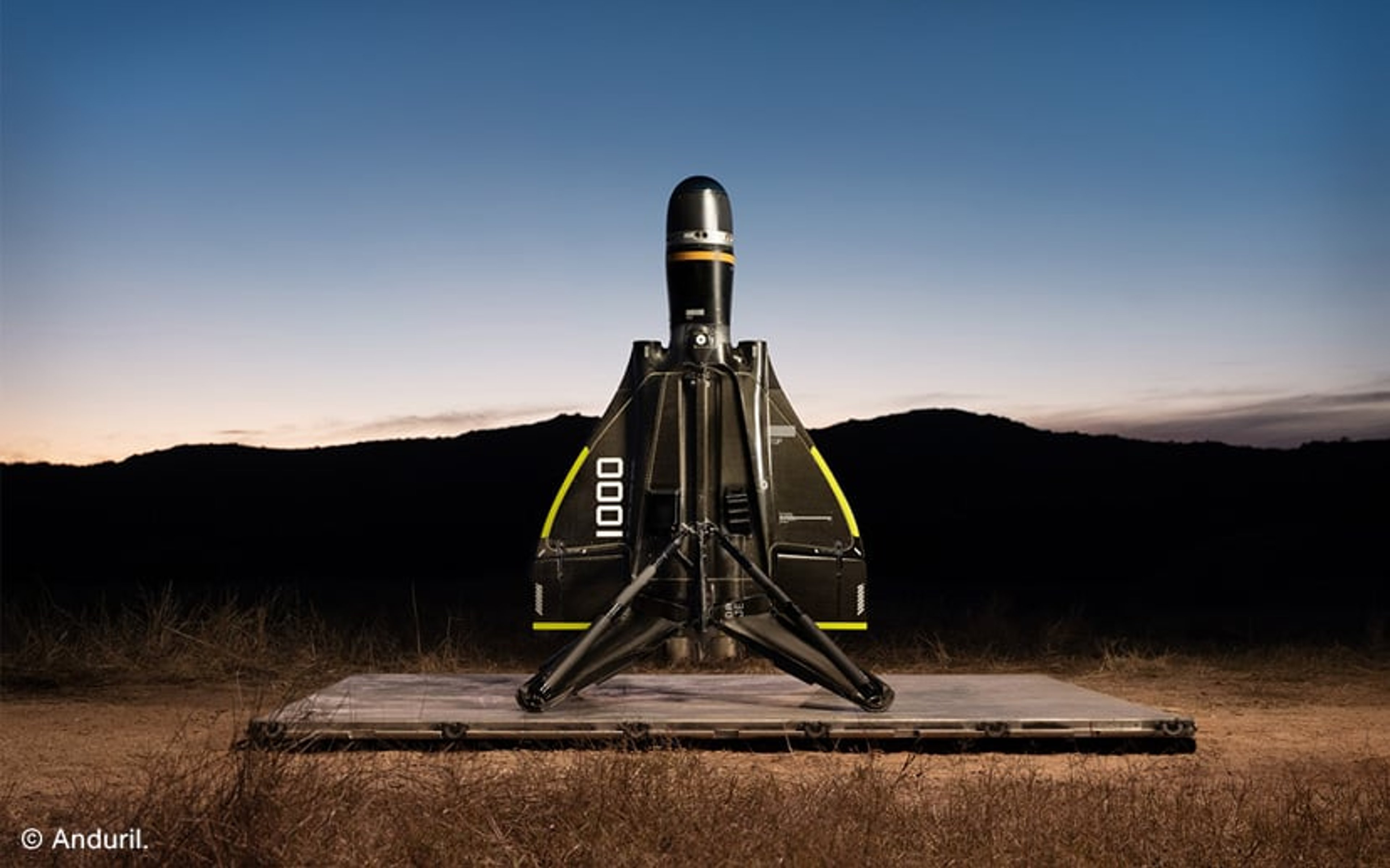 A small rocket drone sat on a launchpd at dusk. © Anduril.