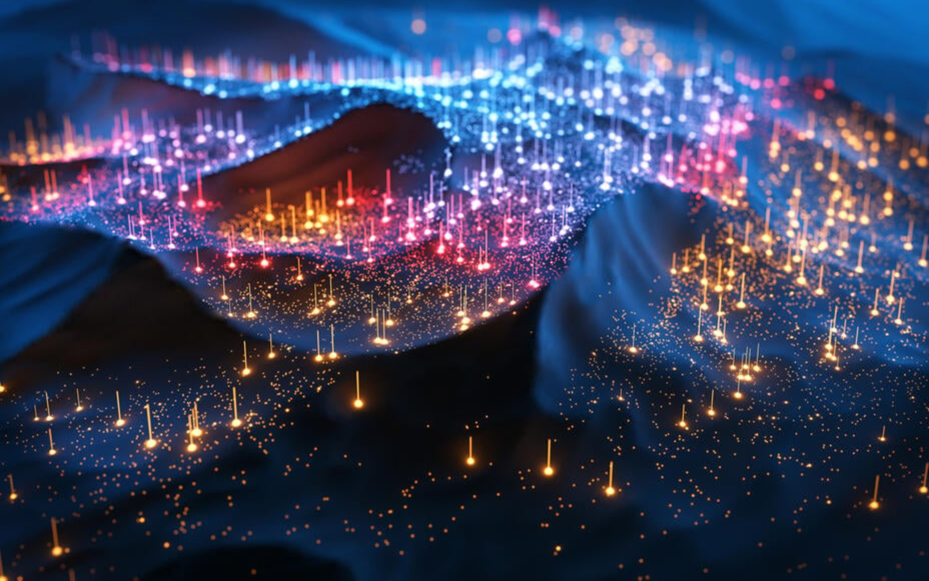 A digitally generated image of multi-coloured glowing data points floating on dark waves.