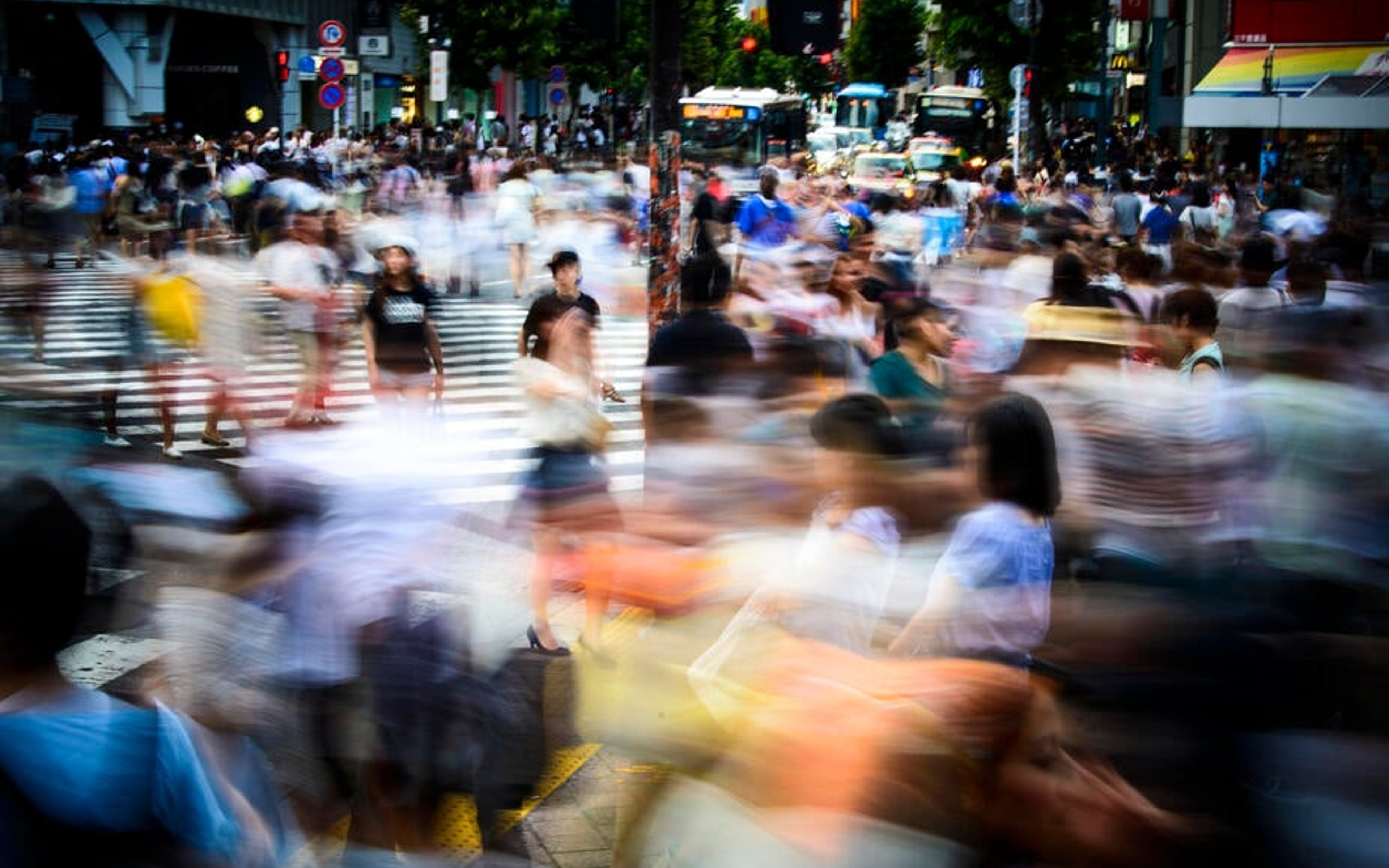 An explosion of motion and colour as a large crowd hurries through central Tokyo.