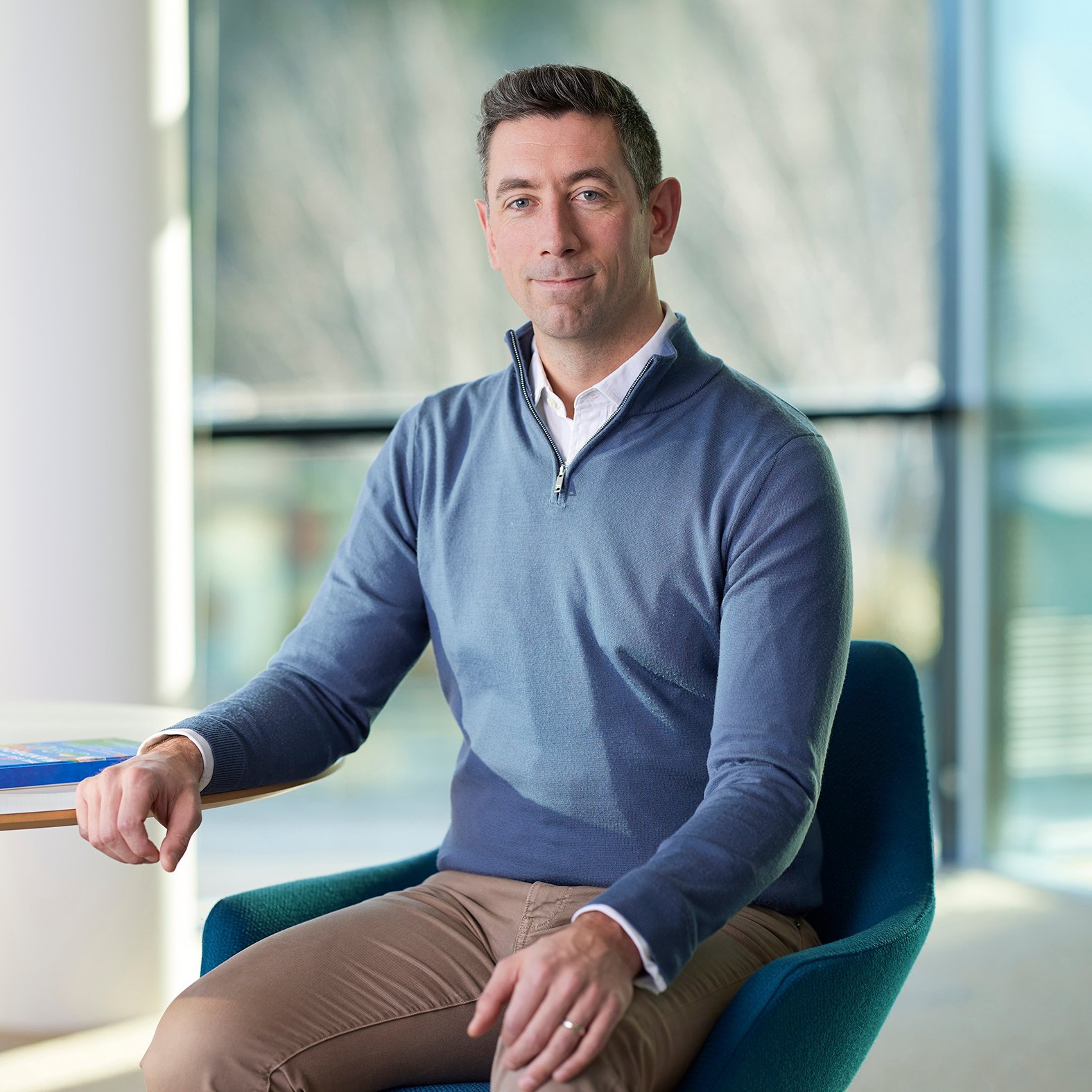 Alasdair McHugh sat leaning against a desk.