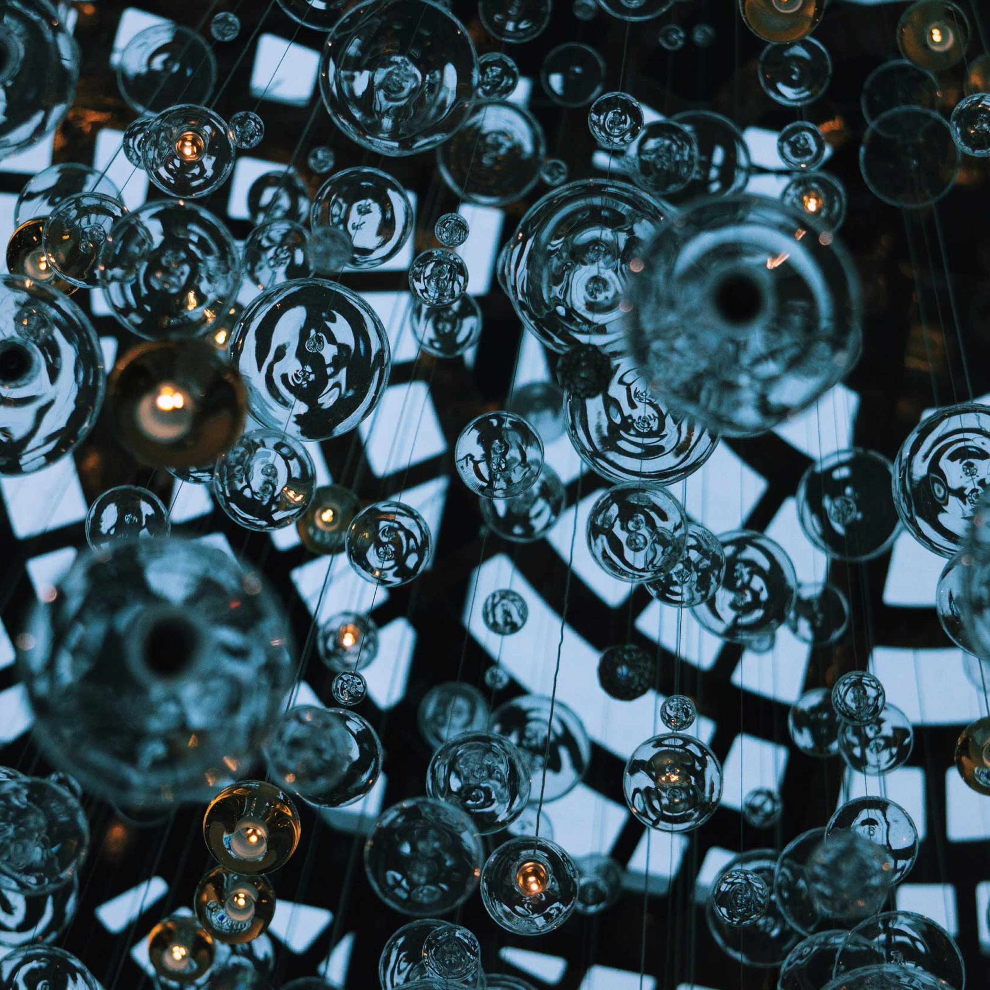 Close up of glass orbs forming a modern chandelier.